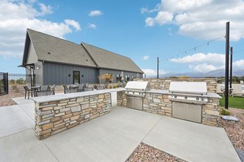A house with a stone wall and a garage.